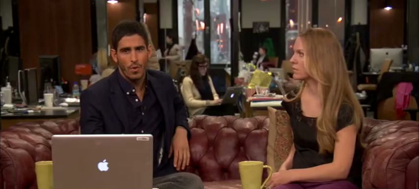 Jenna Miscavige Hill and the host on the HuffPost Live couch, newsroom behind them