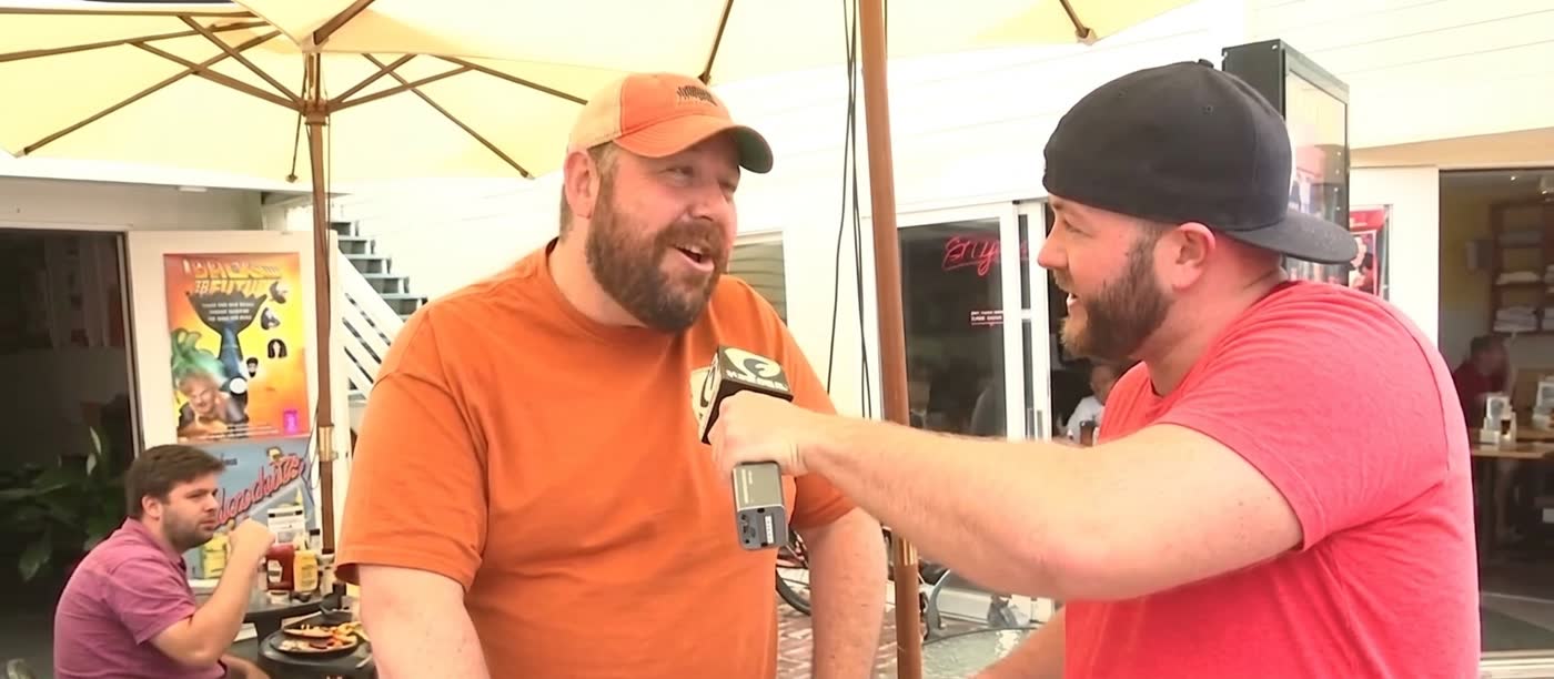 Mitchell Williams interviewing a festival attendee with a Fusion microphone, 2015
