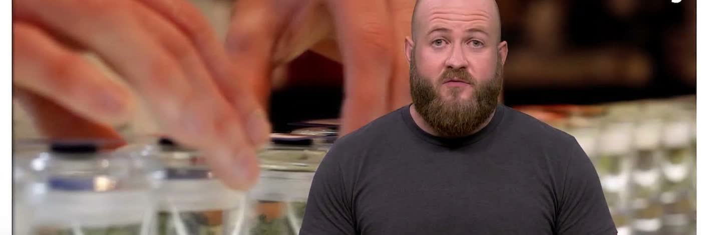 Mitchell Williams hosting an AJ+ explainer behind a row of product jars
